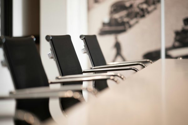 Empty meeting room with executive chairs and long table